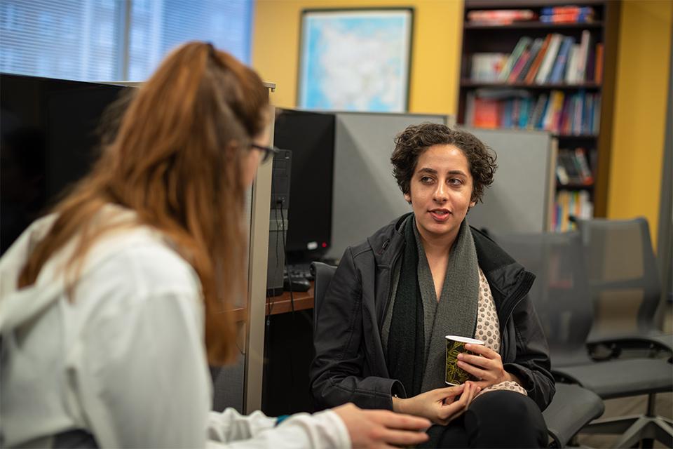 Two students chat at Polyglot Café